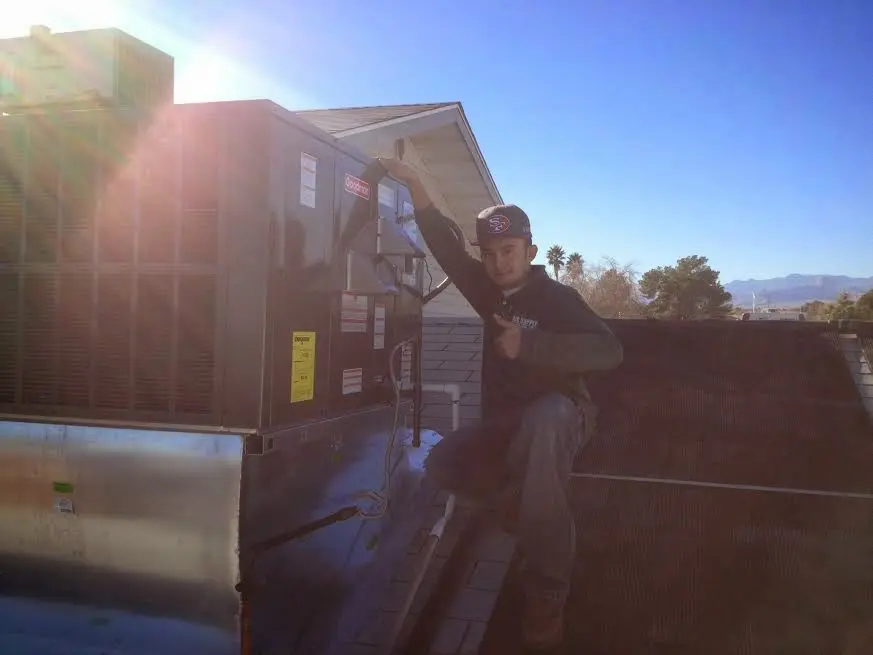 HVAC technician performing Boiler Repair on a rooftop unit in Castle Rock
